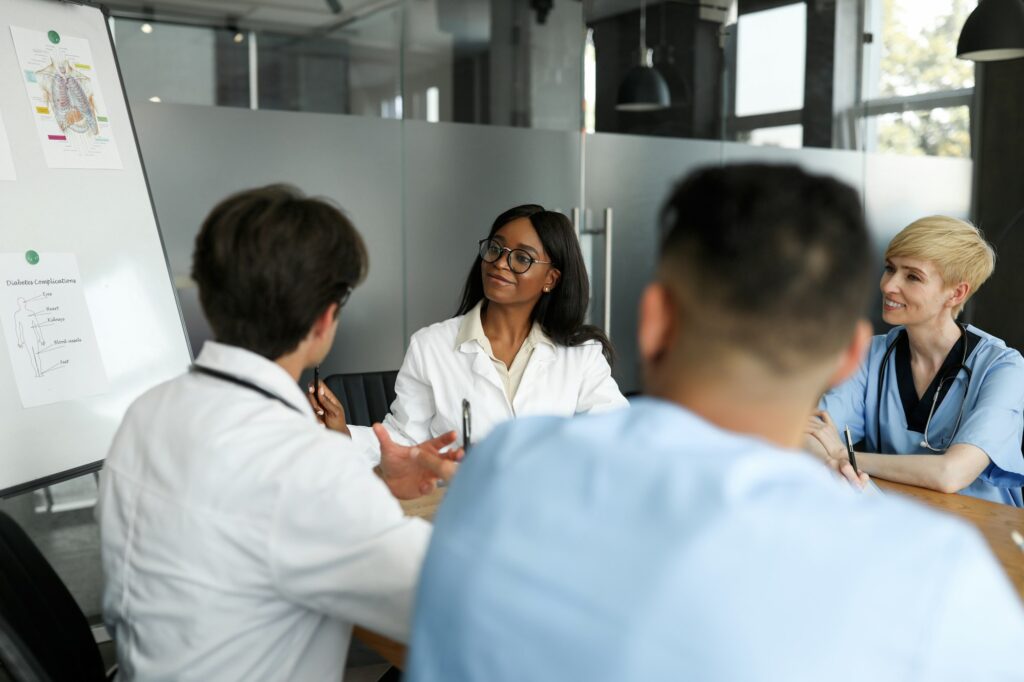 Multiethnic team of doctors having team-building, looking at board